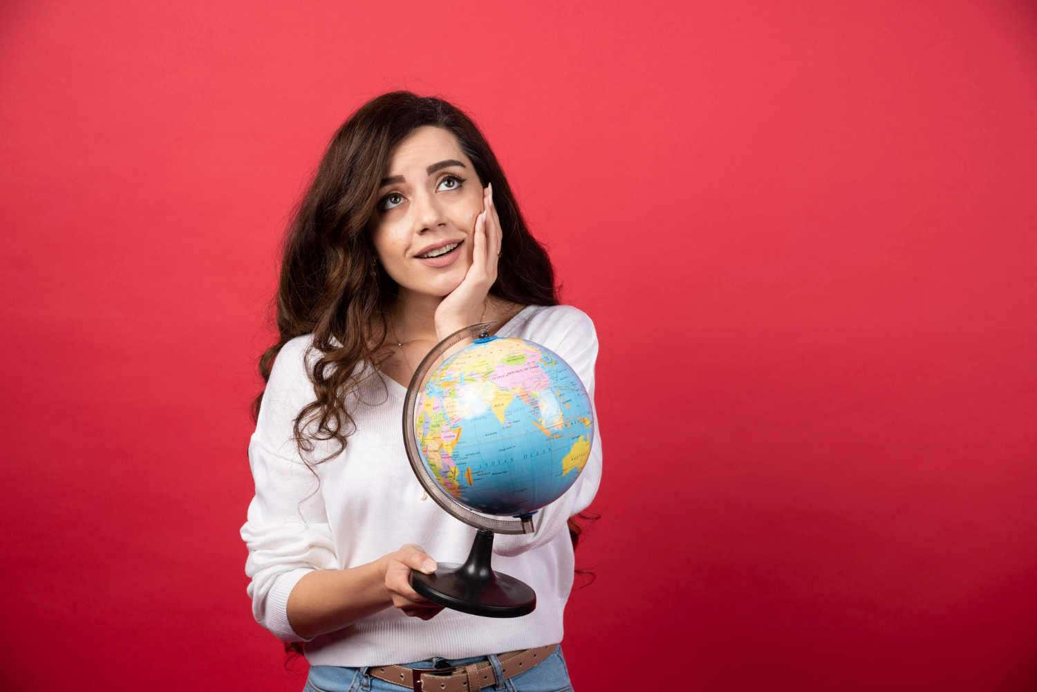 young-woman-with-globe-dreaming-about-travel-Alpha Holidays